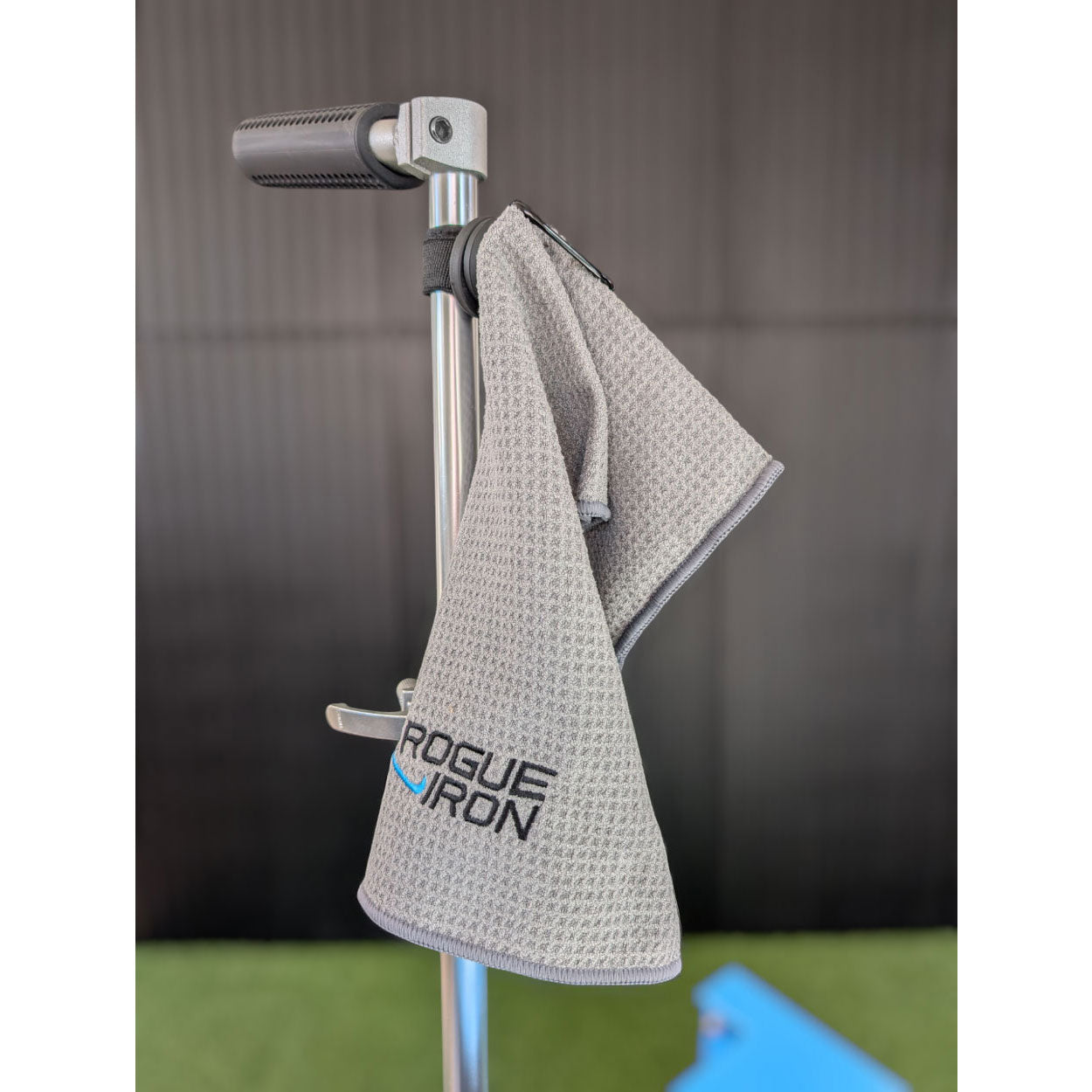 Magnetic disc golf towel attached to a cart